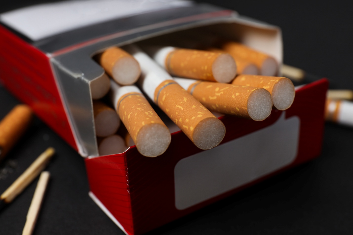 pack-cigarettes-with-matches-dark-background.jpg